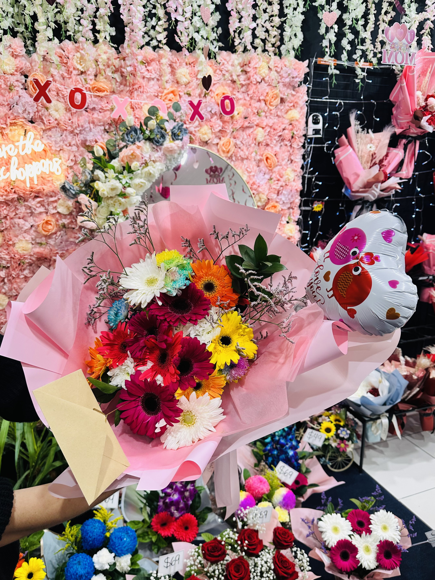 Happy Petals bouquet featuring vibrant colourful gerberas beautifully arranged in elegant pink wrapping, creating a cheerful and joyful floral gift.