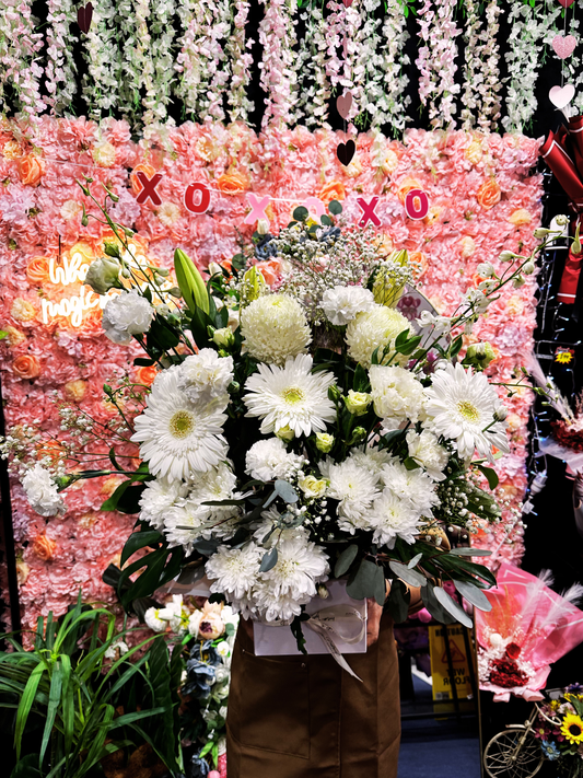 Eternal Grace Floral Box featuring premium white gerberas, chrysanthemums, carnations, lilies, and seasonal blooms elegantly arranged in a sophisticated white floral box.
