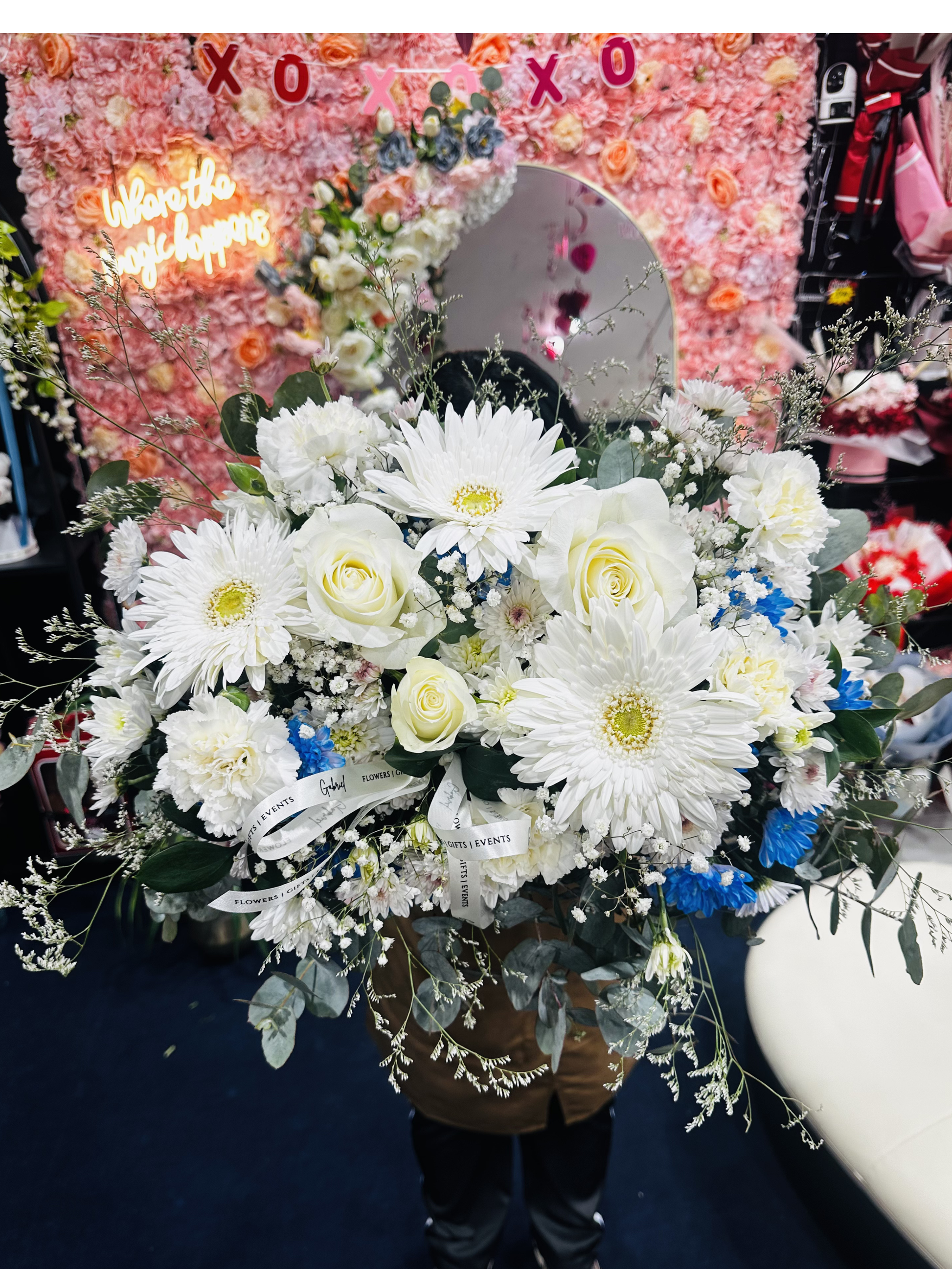 Celestial Grace sympathy arrangement featuring fresh white blooms, soft blue flowers, and delicate greenery designed as an elegant tribute of comfort, love, and remembrance. Fresh flowers on top of coffin. Fresh flowers as a centrepiece.