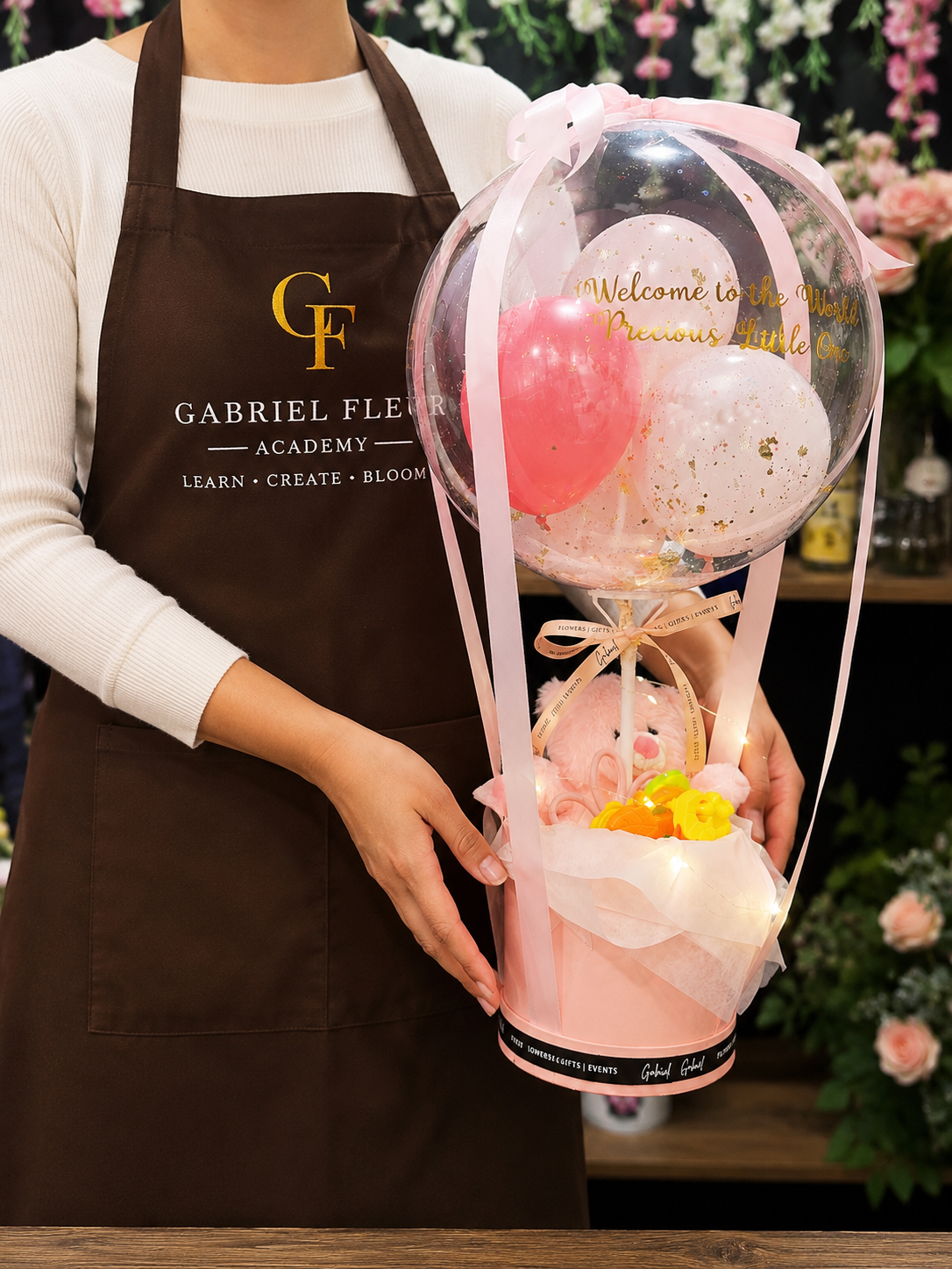Florist holding Hot Air Balloon Hamper from Gabriel Flowers